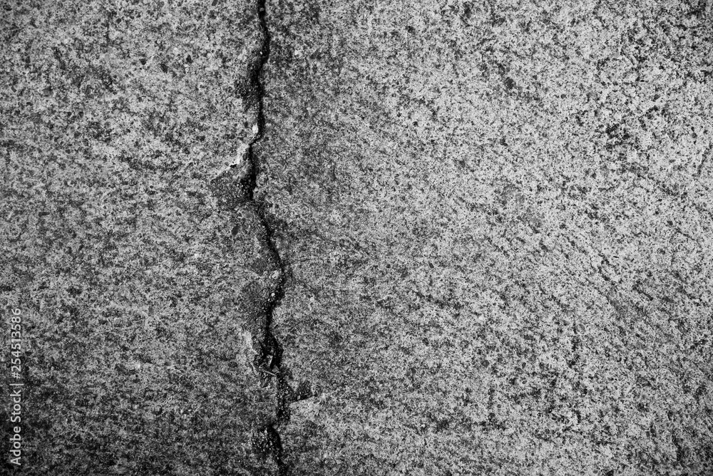 Cracked concrete floor closeup for background. Black and white. Cracked concrete floor closeup for background. Black and white.