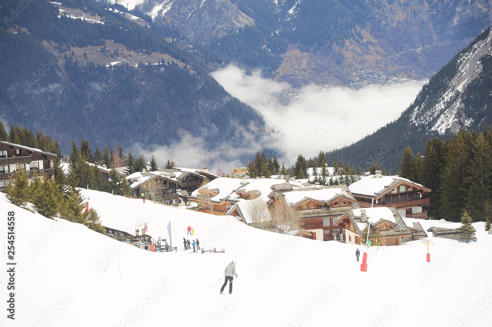 Courchevel village in winter with snow and clouds 