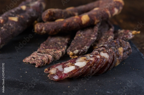 Slicing dried jerks. Cutting from jerkov. Meat snack. photo