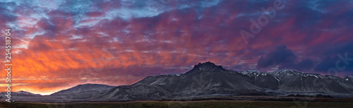 gray mountain under nimbus clouds
