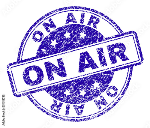 ON AIR stamp seal imprint with distress texture. Designed with rounded rectangles and circles. Blue vector rubber print of ON AIR caption with grunge texture.