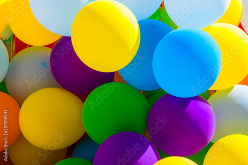 Background of a set of colored balloons on the sky background 