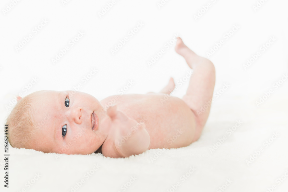 Infant baby portrait in white look at camera Infant baby portrait in white look at camera