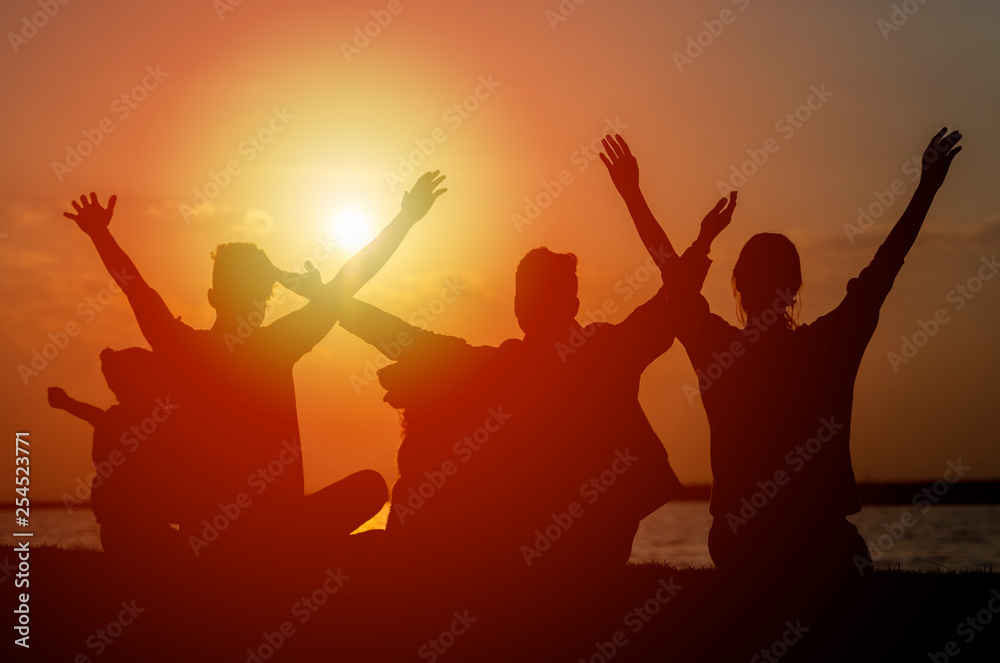 Group of teenagers and child feeling free at sunset Group of teenagers and child feeling free at sunset