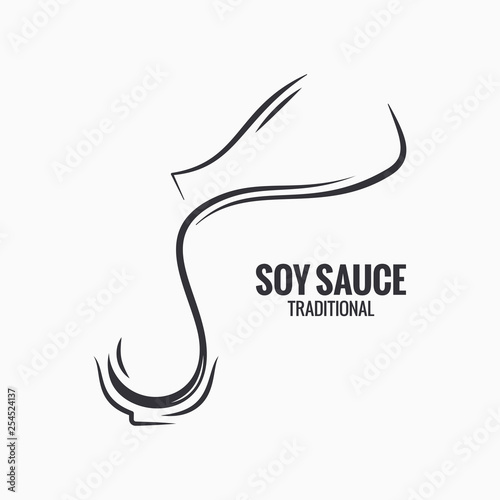 Soy sauce glass. Bottle of soy sauce on white