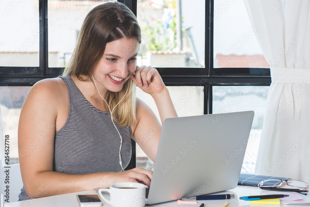 Woman working on laptop at home.