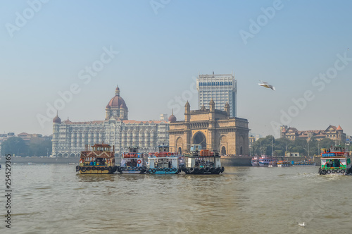 Beautiful Gateway of India near Taj Palace hotel on the Mumbai harbour with many jetties on Arabian sea photo