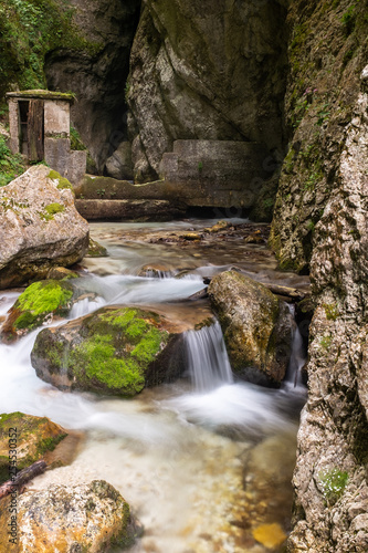 The small creek cascades down through moss covered rocks in a gorge in Le Marche, Italy, long exposure to smooth out the water