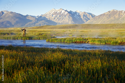 Fototapet One man fly fishing on the Owens River at sunrise with the Sierra Nevada Mountai