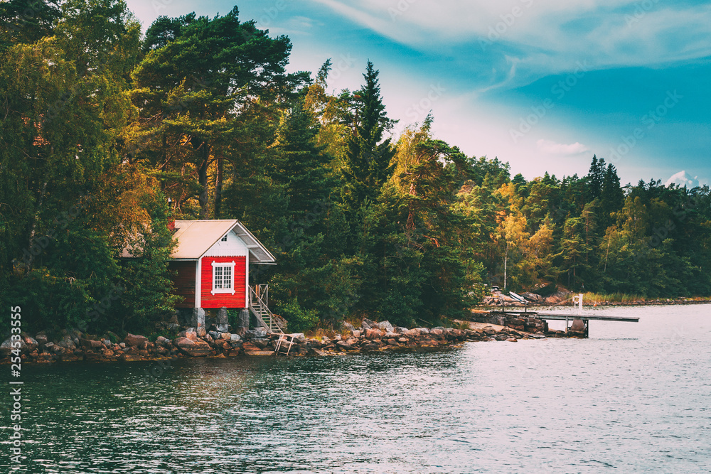 Red Small Finnish Wooden Sauna Log Cabin On Island In Autumn Season