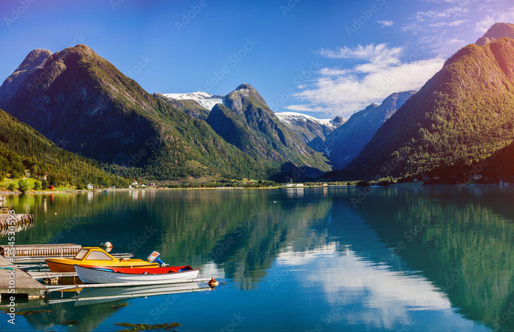 Amazing nature view with boats, fjord and mountains. Beautiful reflection. Norway.