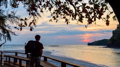 Traveler looking at the sunset on Tarutao island, Thailand