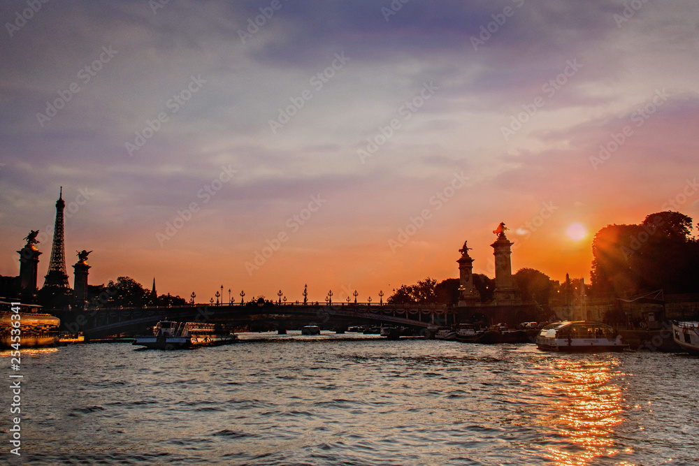 Sunset view and silhouette of bridge from the Seine River in Paris ...