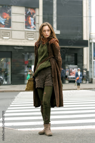 Tall slim girl crosses the road at a crosswalk © alexshalamov