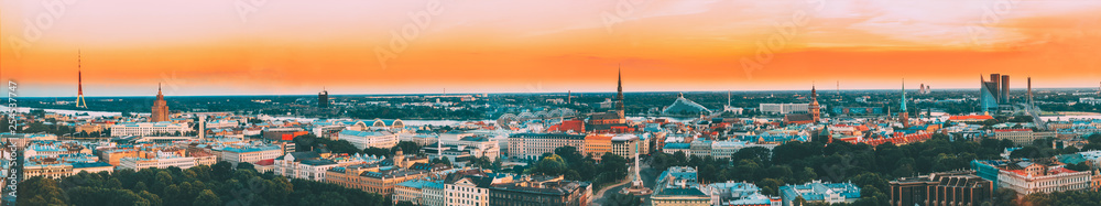 Riga, Latvia. Aerial View Panorama Cityscape At Sunset. TV Tower, Academy Of Sciences, St. Peter's Church, Boulevard Of Freedom, National Library, Dome Cathedral, Basilica Of St. James