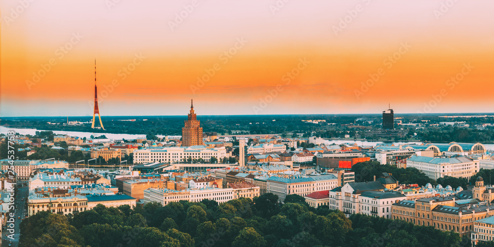 Riga, Latvia. Aerial View Panorama Cityscape At Sunset. TV Tower, Academy Of Sciences