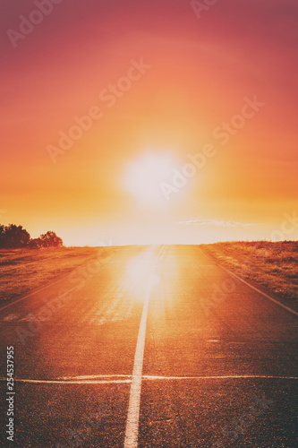 Fototapeta Naklejka Na Ścianę i Meble -  Asphalt Country Open Road In Sunny Morning Or Evening. Open Road In Summer Season At Sunny Sunset Or Sunrise Time