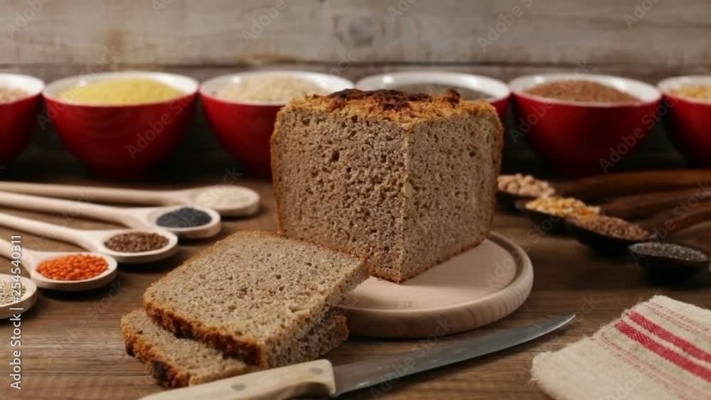 Multicereal and multigrain bread on display, with the various ingredients around on spoons and in bowls - healthy whole food concept Multicereal and multigrain bread on display, with the various ingredients around on spoons and in bowls - healthy whole food concept