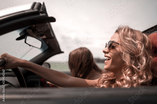 close up. fashionable blonde driving a convertible