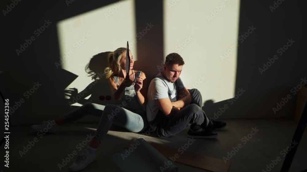 Young couple had quarreled because of the renovation of their flat or apartment Young couple had quarreled because of the renovation of their flat or apartment