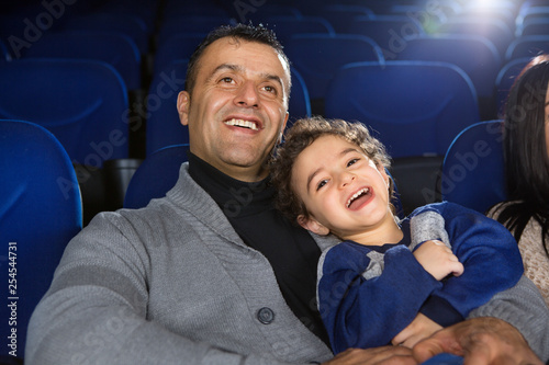 Happy family watching movies at the cinema