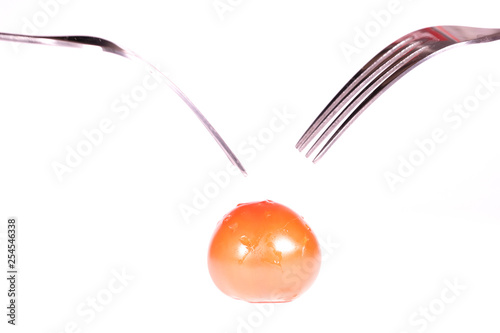 image of a tomato pinned on 2 forks