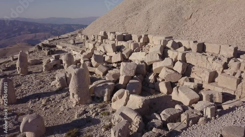 aerial 4K hd drone shot over fallen Commogene empire tomb ruins on Mount Nemrut, sunny and dry weather, dusty area, in Adiyaman Province, Turkey photo