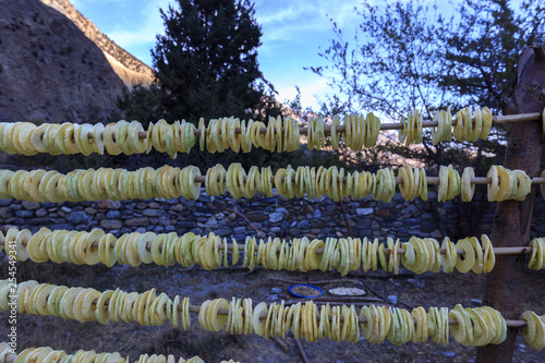 Dried apple slices on a rack near a apple orchard in Marpha (2,700m high), on the Annapurna ciruit, Nepal photo