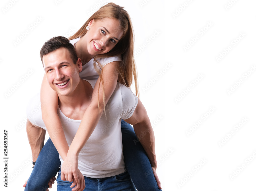 Handsome man piggybacking his girlfriend on white