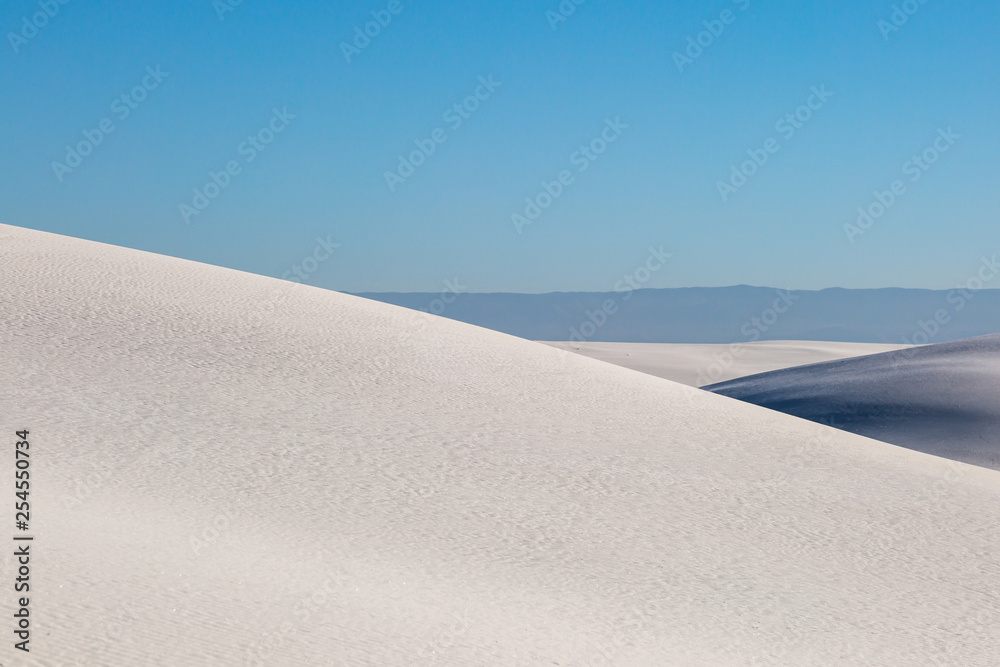 Gypsum Sand Dunes at White Sands National Monument, with a blue sky overhead Stock Photo Adobe