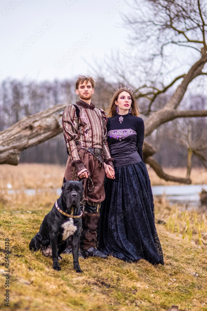 Costume Play. Couple as Knight Warrior and Princess with Black Dog Posing  in Medieval Clothing in Spring Forest Outdoors. Stock Photo | Adobe Stock