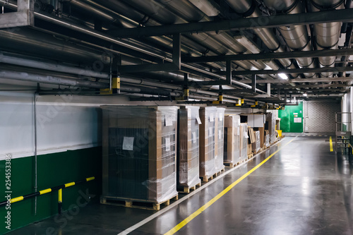 Industrial warehouse corridor. Goods in carton and polyethylene packaging