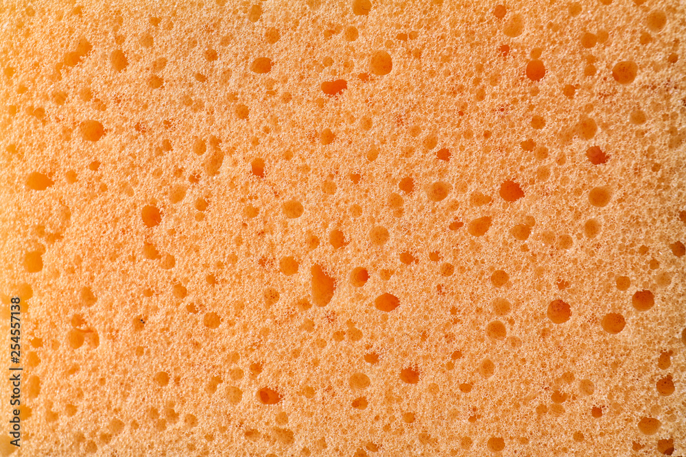 Texture of orange sponge as background, closeup Texture of orange sponge as background, closeup
