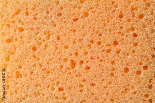 Texture of orange sponge as background  closeup