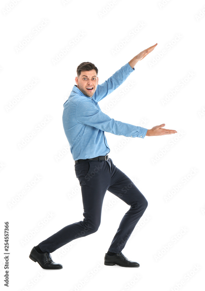 Emotional man in office wear holding something on white background