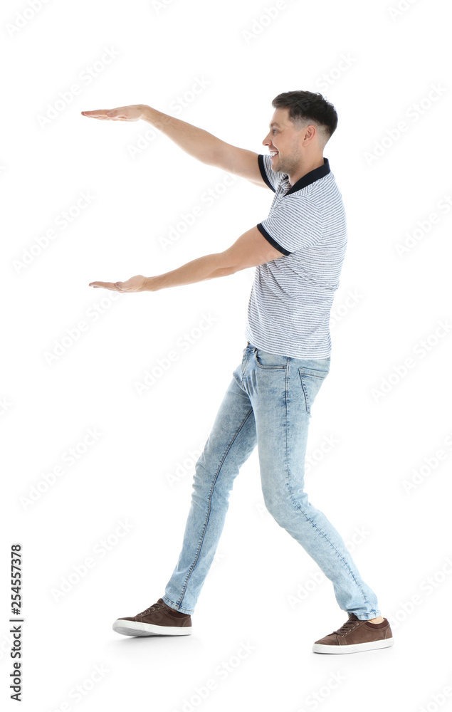 Man in casual clothes holding something on white background Man in casual clothes holding something on white background