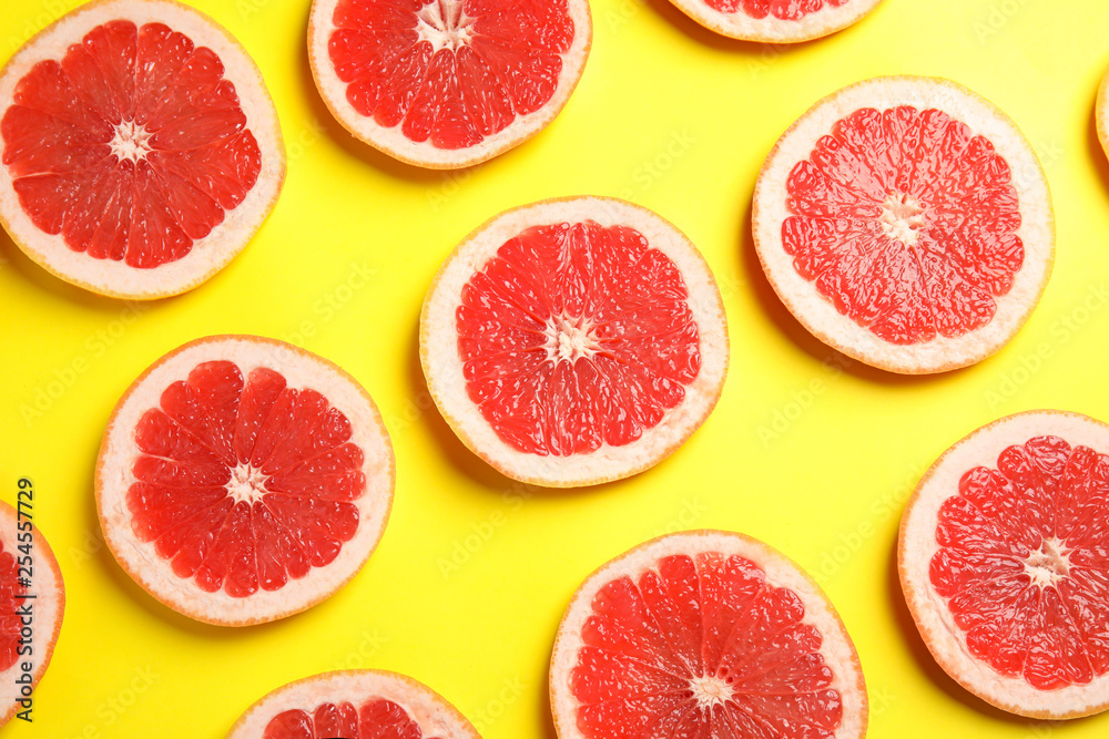 Fresh sliced ripe grapefruits on color background, flat lay Fresh sliced ripe grapefruits on color background, flat lay