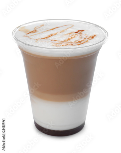 Plastic cup of tasty caramel macchiato on white background