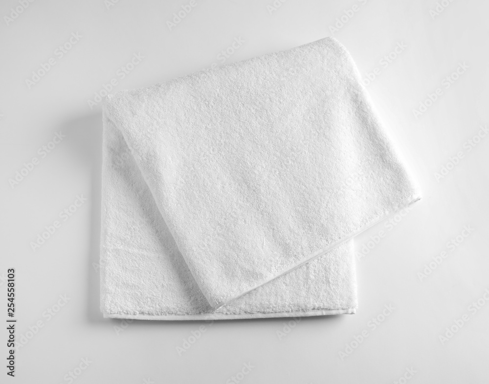 Folded soft terry towel on light background, top view Folded soft terry towel on light background, top view