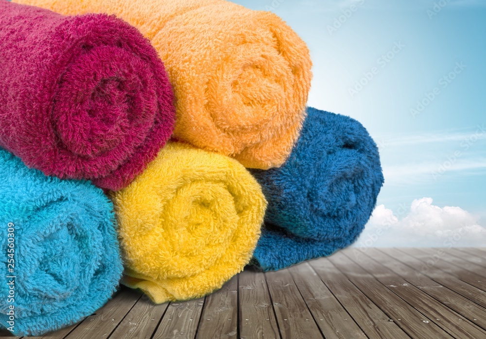 Laundry Basket with colorful towels on background Laundry Basket with colorful towels on background