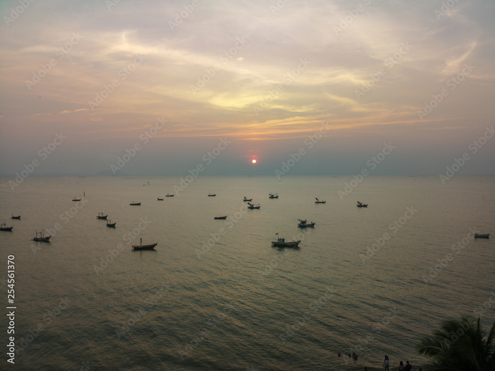 Naklejka premium Boat on the sea at sunset