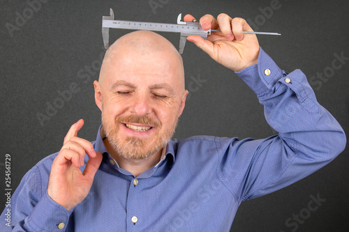 man measures the size of his head measuring device caliper