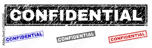 Grunge CONFIDENTIAL rectangle stamp seals isolated on a white background. Rectangular seals with grunge texture in red, blue, black and gray colors.