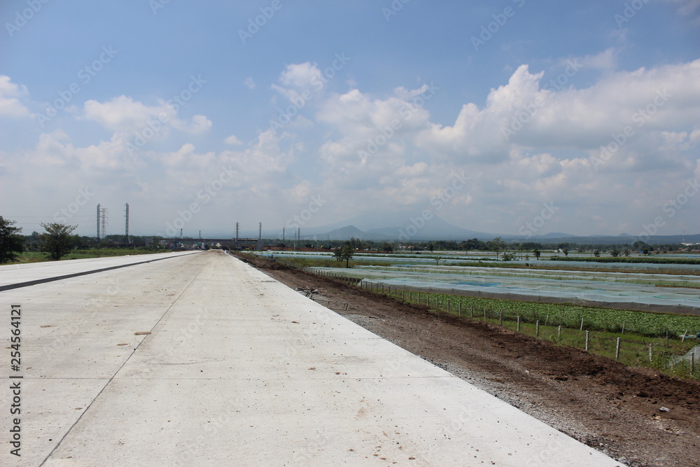 Concrete Road Near Rice Fields in Indonesia