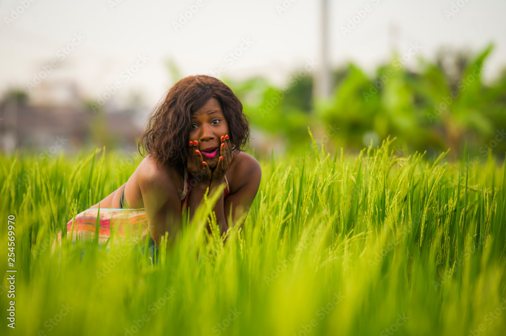 lifestyle portrait of young attractive and happy black afro American woman posing cheerful having fun outdoors at beautiful rice field background enjoying holidays trip lifestyle portrait of young attractive and happy black afro American woman posing cheerful having fun outdoors at beautiful rice field background enjoying holidays trip