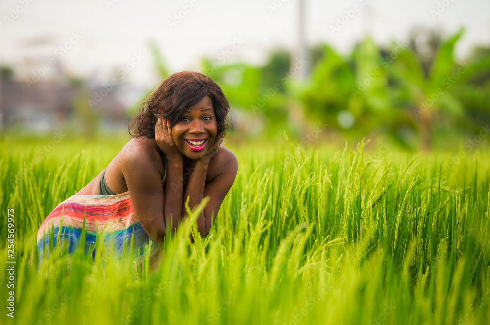 lifestyle portrait of young attractive and happy black afro American woman posing cheerful having fun outdoors at beautiful rice field background enjoying holidays trip lifestyle portrait of young attractive and happy black afro American woman posing cheerful having fun outdoors at beautiful rice field background enjoying holidays trip