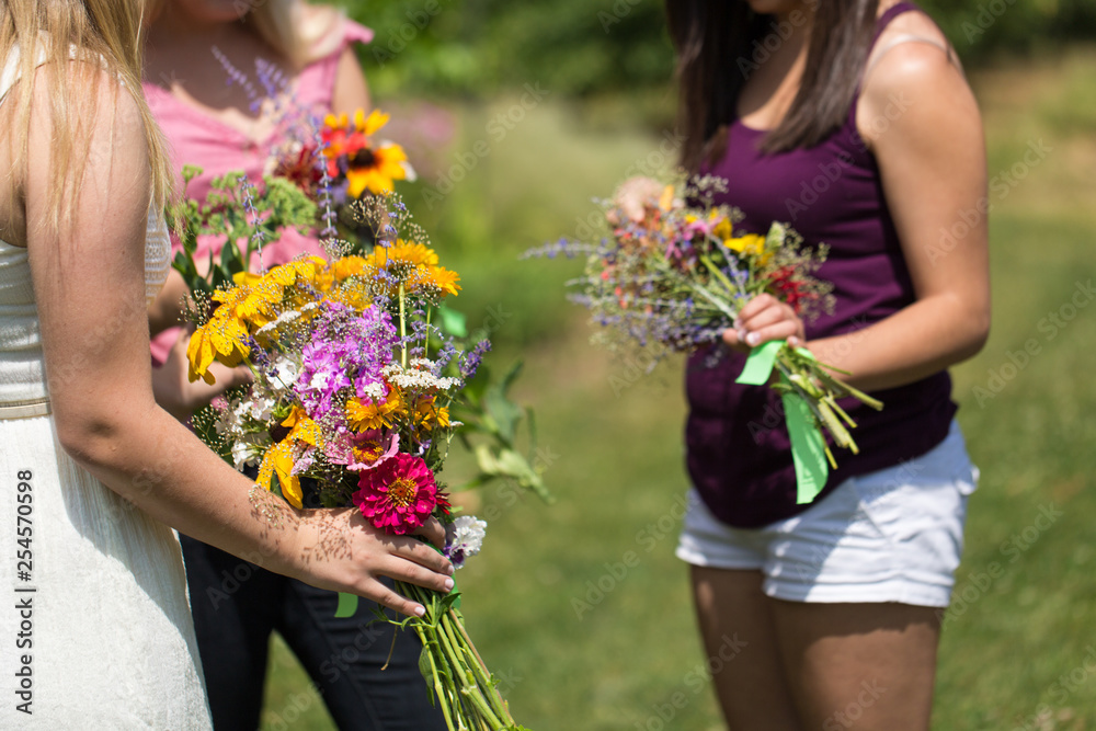women picking wildflower bouquets