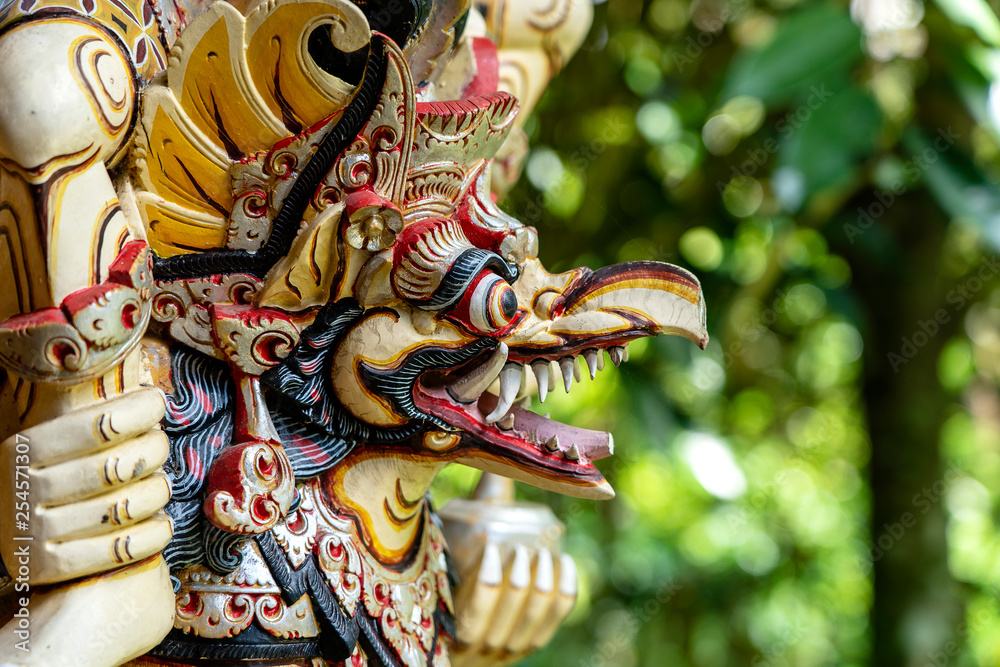 Balinese ancient colorful bird god Garuda with wings, closeup