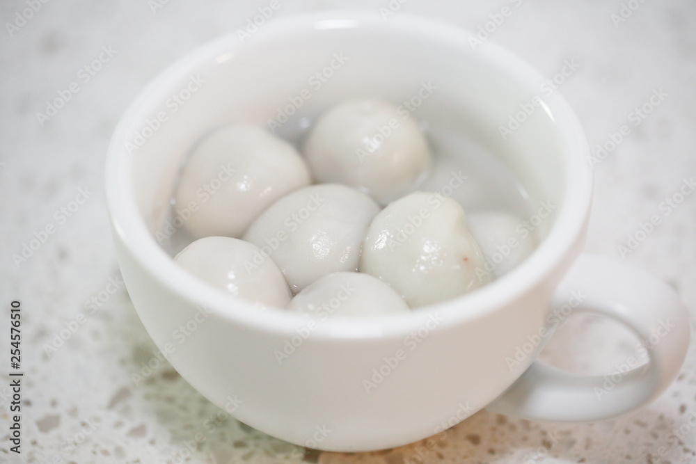 Flat lay Chinese food `tang yuan` glutinous rice ball sweet hot soup on kitchen table top. - Image Flat lay Chinese food `tang yuan` glutinous rice ball sweet hot soup on kitchen table top. - Image