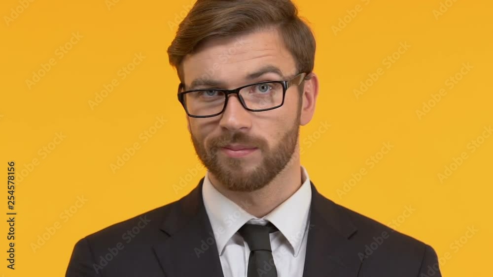 Bearded man shaking piggy-bank near ear, lack of finances, small interest rate Bearded man shaking piggy-bank near ear, lack of finances, small interest rate